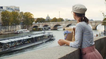 Young girl on a bridge in Paris, Franceの写真素材