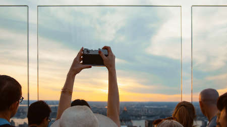 Young girl taking a photo from the roof, NYCの写真素材