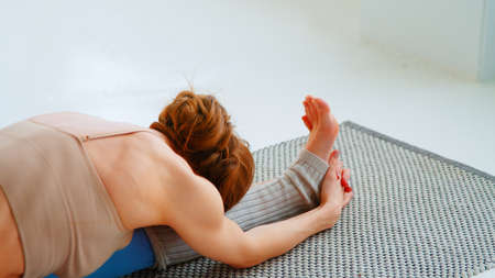 Close-up of young woman with exercise mat for yoga training