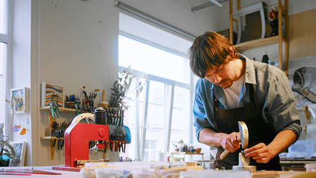 Young master working with mosaic in a creative studioの写真素材