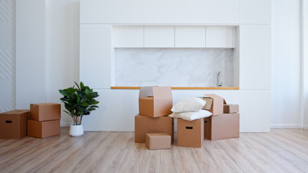Unpack brown cardboard box in new apartment after relocation to houseの写真素材