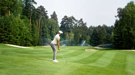 Young golfer in uniform playing golf outdoorsの写真素材