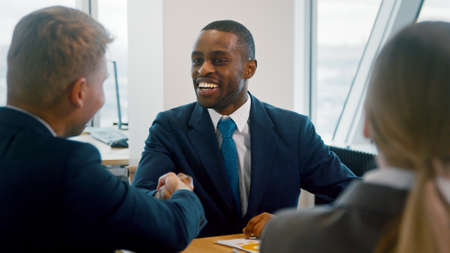 Businessmen and businesswoman meeting in office. Smiling ceo with work groupの写真素材