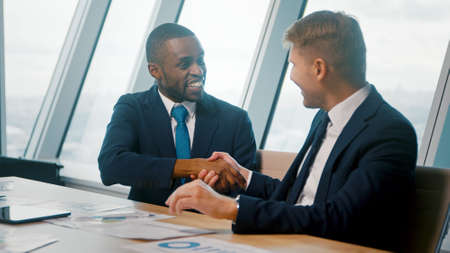 Man leader and businessman in suits discussing project in officeの写真素材