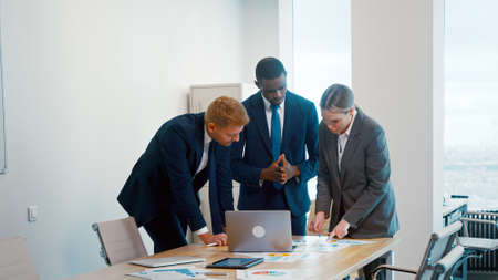 Young multiracial business people enjoying working together at office. Young business people discussing a projectの写真素材