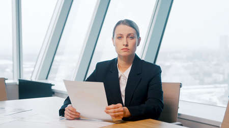 Young girl in a suit discussing via video call in the office. young businesswoman at video conferenceの写真素材
