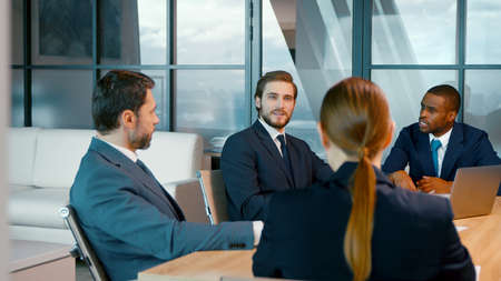 Group of business people talking and working at the desk in the office. Business people discussing a new projectの写真素材
