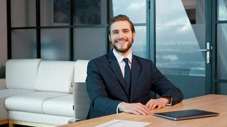 Young businessman at video conference. young man looking at camera consult clientの写真素材