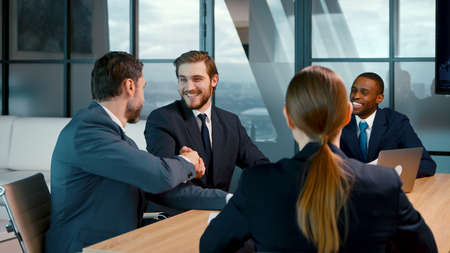 A group of people at a business meeting. Handshake of successful business people at a meeting in the officeの写真素材