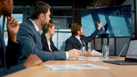 Business analysts discussing a project at a meeting in the office. Young people working using technology in the officeの写真素材