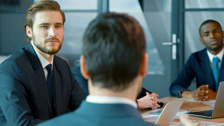 Corporate business team in a meeting with a manager. Young group of diverse business peopleの写真素材