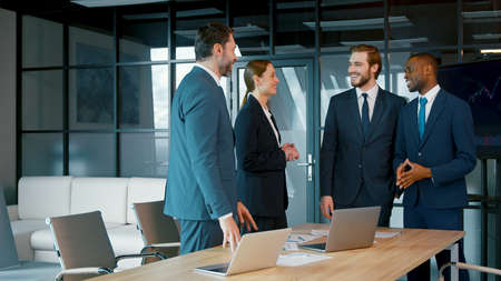 Corporate business team in a meeting. Group of young people in suits in the officeの写真素材