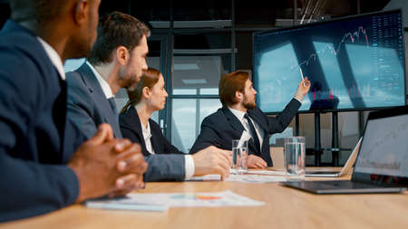 Business analysts discussing a project at a meeting in the office. Young people working using technology in the officeの写真素材