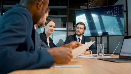 Serious business analysts discussing a project at a meeting in the officeの写真素材
