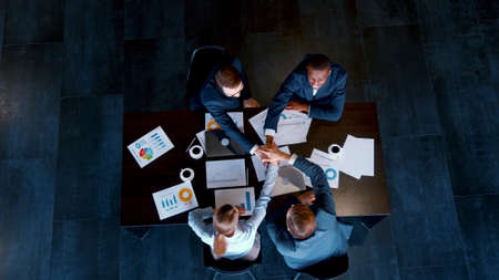 Concept of unity and teamwork. Young business people at meeting in the loftの写真素材