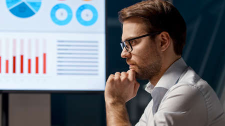 Thinking young businessman at work in office meeting roomの写真素材