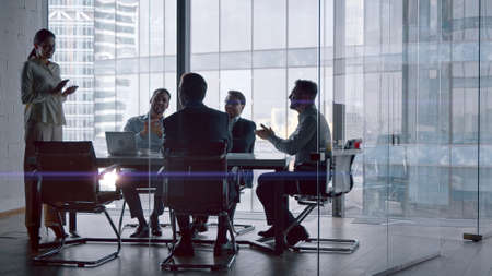 Professionals at work: business team discussing financial strategies in a crisis while sitting at desk in a meeting roomの写真素材