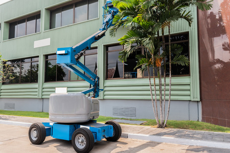 High-rise building maintenance engineers using cranesの写真素材