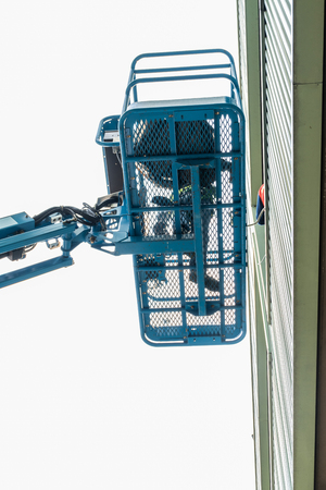 High-rise building maintenance engineers using cranesの写真素材