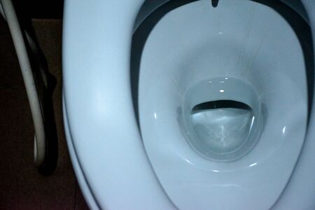 Closeup view of a flushing white toiletの写真素材