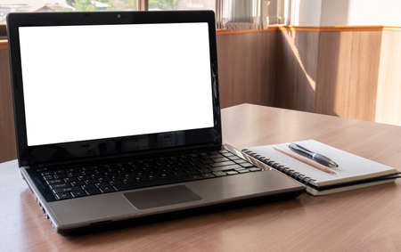 Laptop with a pen and notebook on the table in meeting roomの写真素材