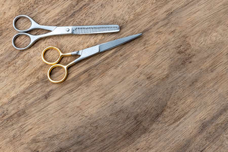 Barber scissors with copy space on wood background.