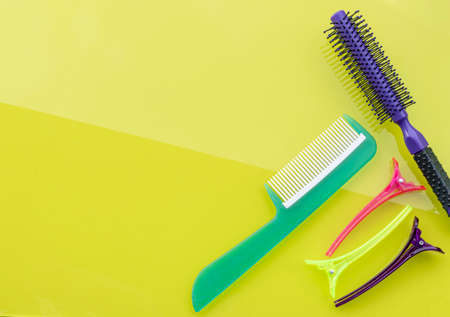 Beauty copy space on green background. Hairbrush and Hairpin