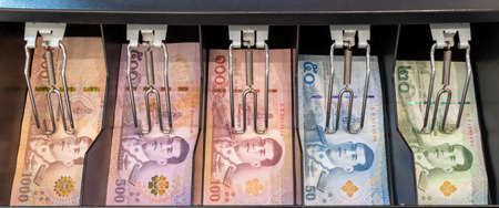23 July 2020 Pathumthani Thailand Colorful Thai bank notes in the cashier drawerのeditorial素材