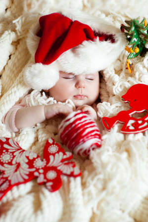 Angelic infant in santa hat sleeping and having christmassの写真素材