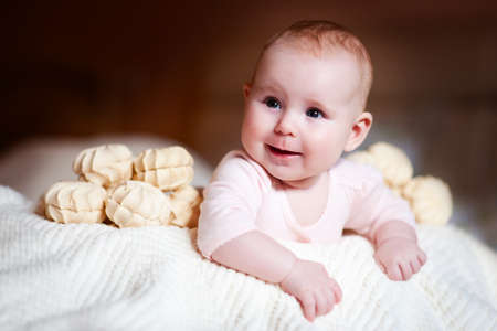 Happy newborn baby with marshmallow smiling