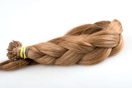 Plait made of faux hair for beauty salolon blond color on gray backgroundの写真素材