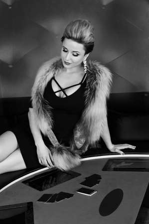 Black and white portrait of erotic sexy passion young woman in lingerie model ready to play poker cards in casinoの写真素材