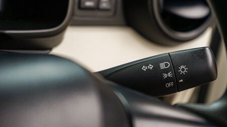 Close up of car headlight control lever