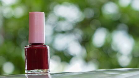 Close up of red nail polish on the tableの写真素材