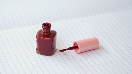 Close up of red nail polish on the tableの写真素材