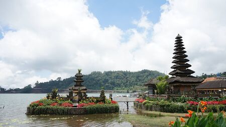 View of the Hindu Temple building by the lakeの写真素材