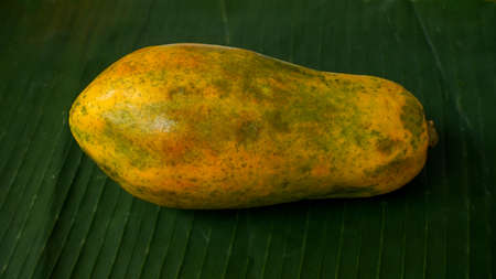 Close up papaya fruit on a banana leafの写真素材