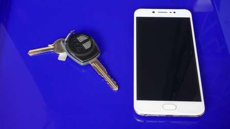 Close up smartphone and car keyの写真素材