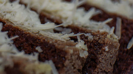 Close up of sliced chocolate cake with cheese toppingの写真素材