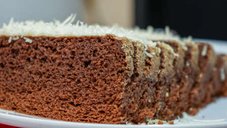 Close up of sliced chocolate cake with cheese toppingの写真素材