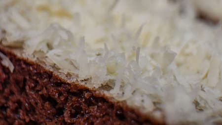 Close up of sliced chocolate cake with cheese toppingの写真素材