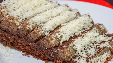 Close up of sliced chocolate cake with cheese toppingの写真素材