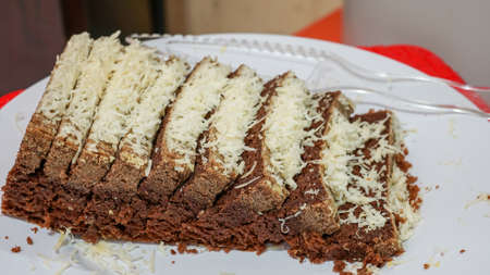 Close up of sliced chocolate cake with cheese toppingの写真素材