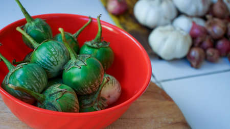 Close up of small green eggplant on the tableの写真素材