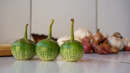 Close up of small green eggplant on the tableの写真素材