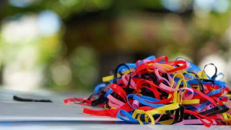 Close-up of colorful rubber bands on the tableの写真素材