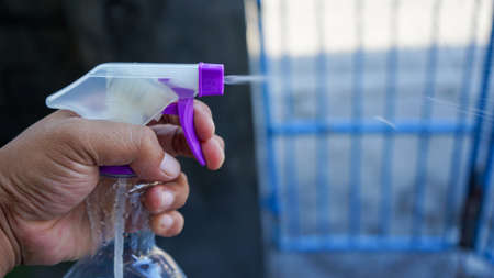 Close up of hands holding hand sanitizerの写真素材
