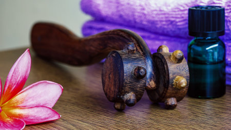Spa composition with a wooden massage tool, towel and flower.の写真素材