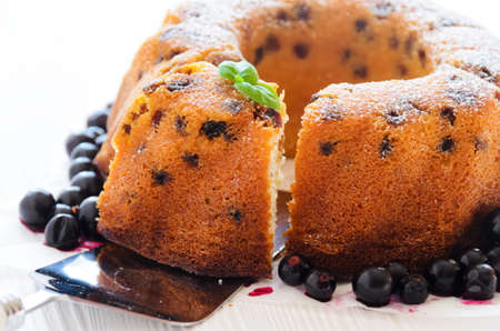 Ring cake with raisins and berries on a white background, closeupの写真素材