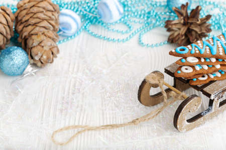 Christmas background with gingerbread and decotations, white table, space for textの写真素材